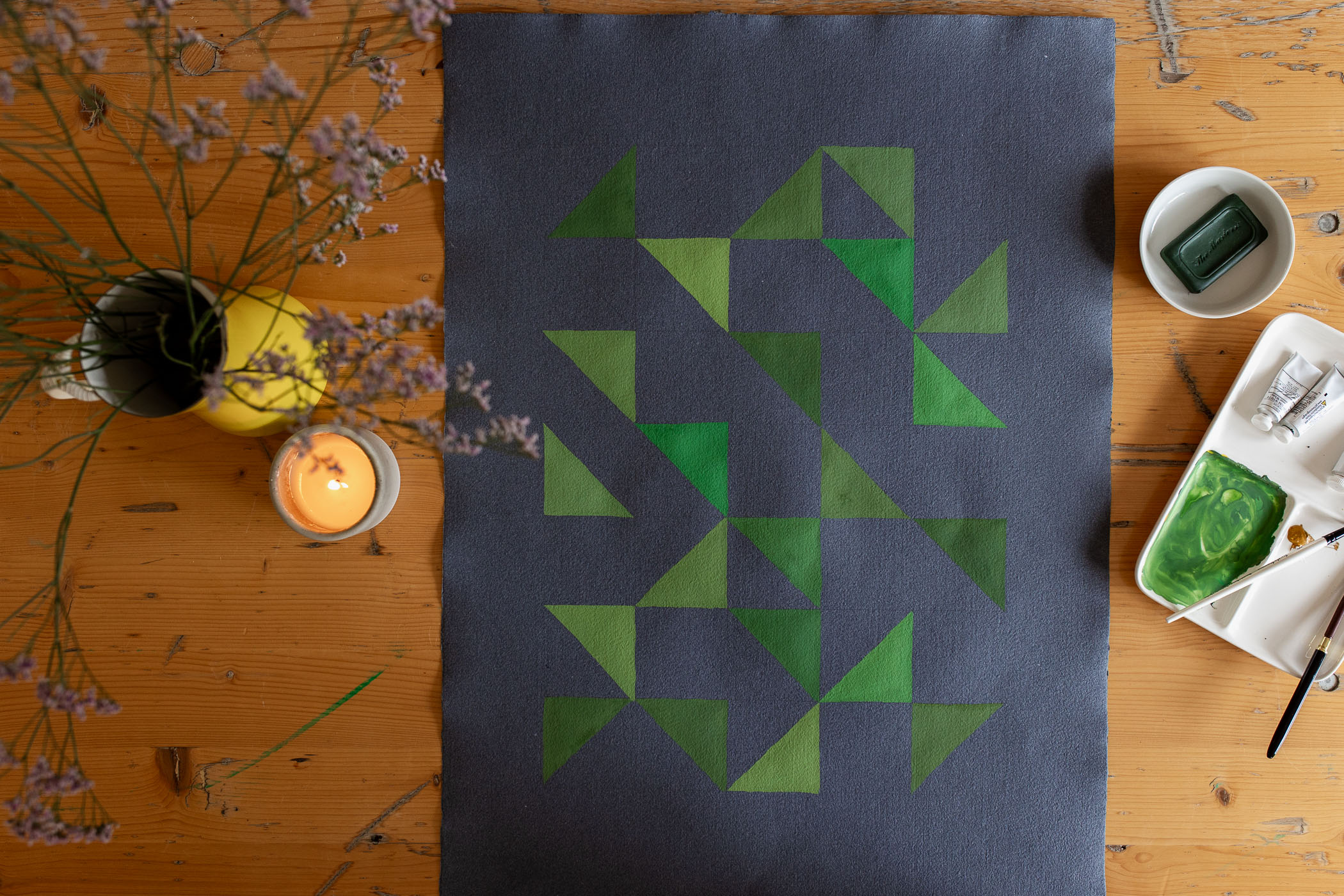 guache geometric paintings laying on a table