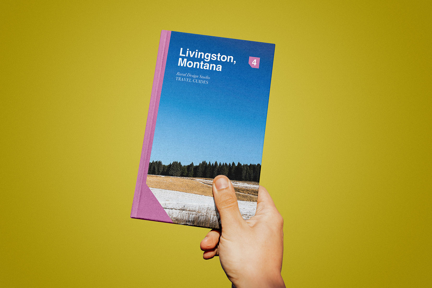 hand holding rural travel guide book